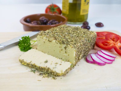 Sliced vegan herb-crusted cashew cheese