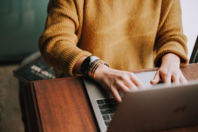 Woman typing at her laptop