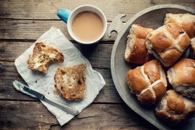 Vegan Hot Cross Buns presented with a cup of tea