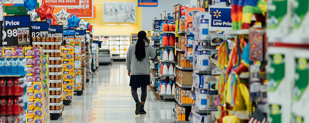 Man in a supermarket - our vegan food label guide helps understand what to look out for.