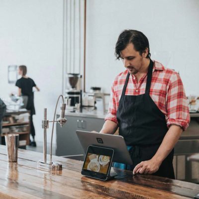 A young Caucasian man working in a coffee shop. Even corporations can get involved with Veganuary.