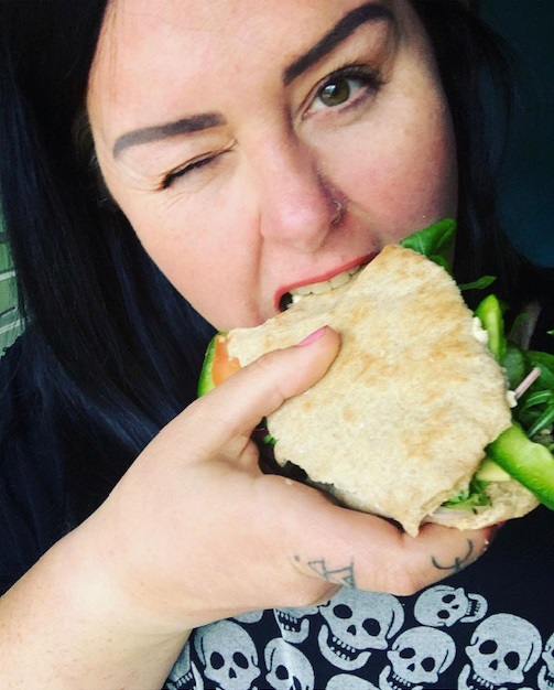 Emma, Veganuary participant, eating a sandwich. She found that her cholesterol levels came down after going vegan.
