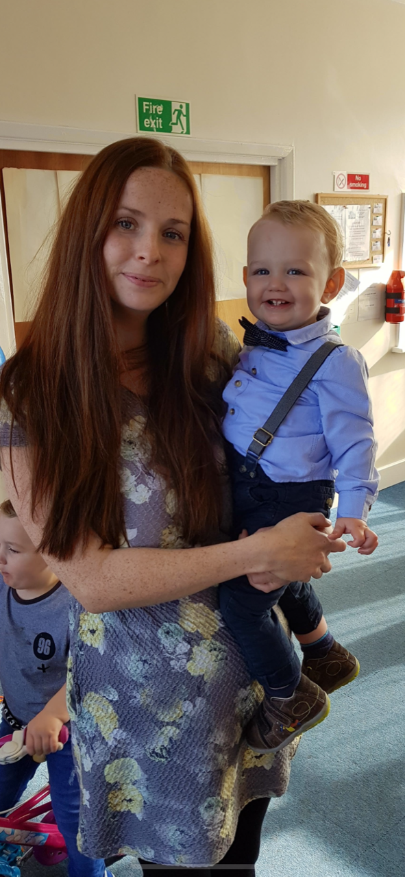 A woman, Laura, holding her baby son. Laura became a vegan mum and is happy with her decision. 