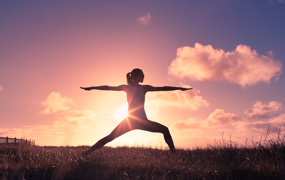 Woman doing yoga pose outside