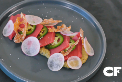 Fresh vegan tuna crudo garnished with fresh radish and lotus root