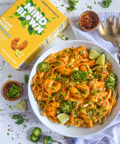 A large white bowl of vibrant and colorful Bang Bang Mind Blown Dusted Shrimp Linguine