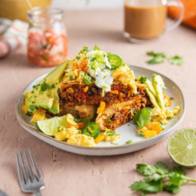 Bright, fresh, Huevos Rancheros piled high on a white dish