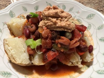 A rich chili tops a baked potato