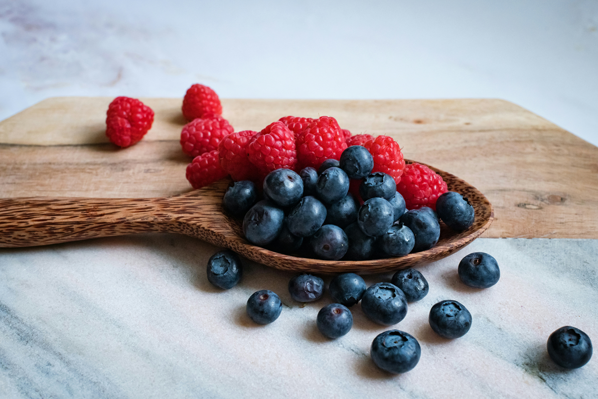 Blueberries and raspberries on a worktop